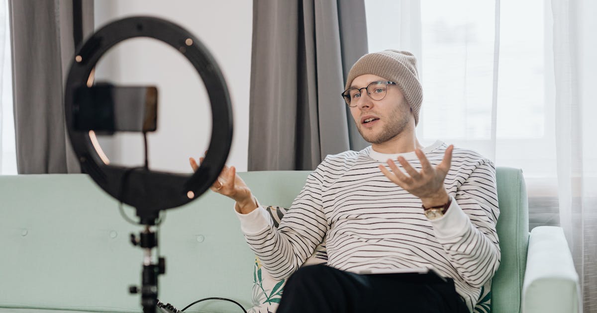 YouTube vlogger using professional lighting setup for indoor video recording